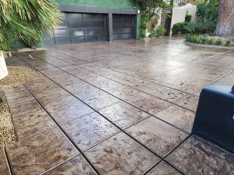 A backyard patio and pool deck feature stamped concrete with wood patterns. polished decorative concrete